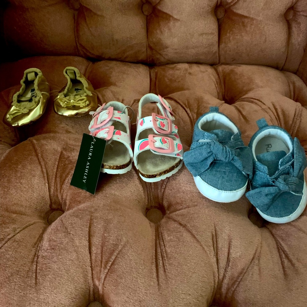Three pairs of baby shoes.